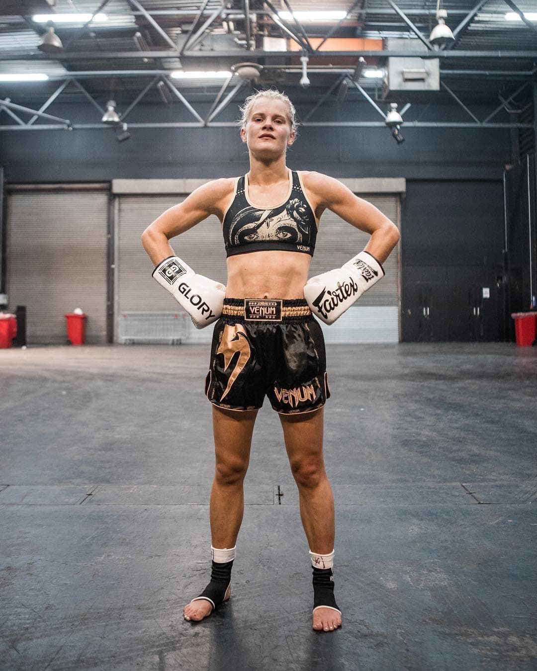 Christi in Muay Thai gear, standing in the gym